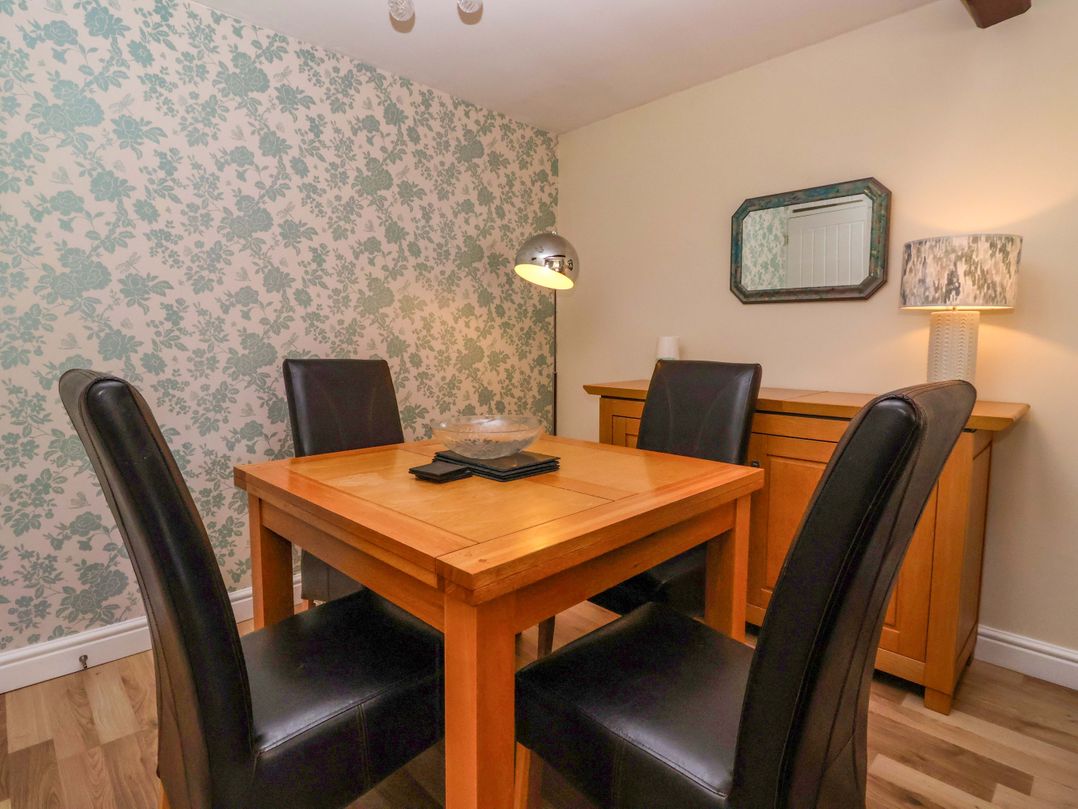 A dining room with a wooden table and chairs at The Granary in York