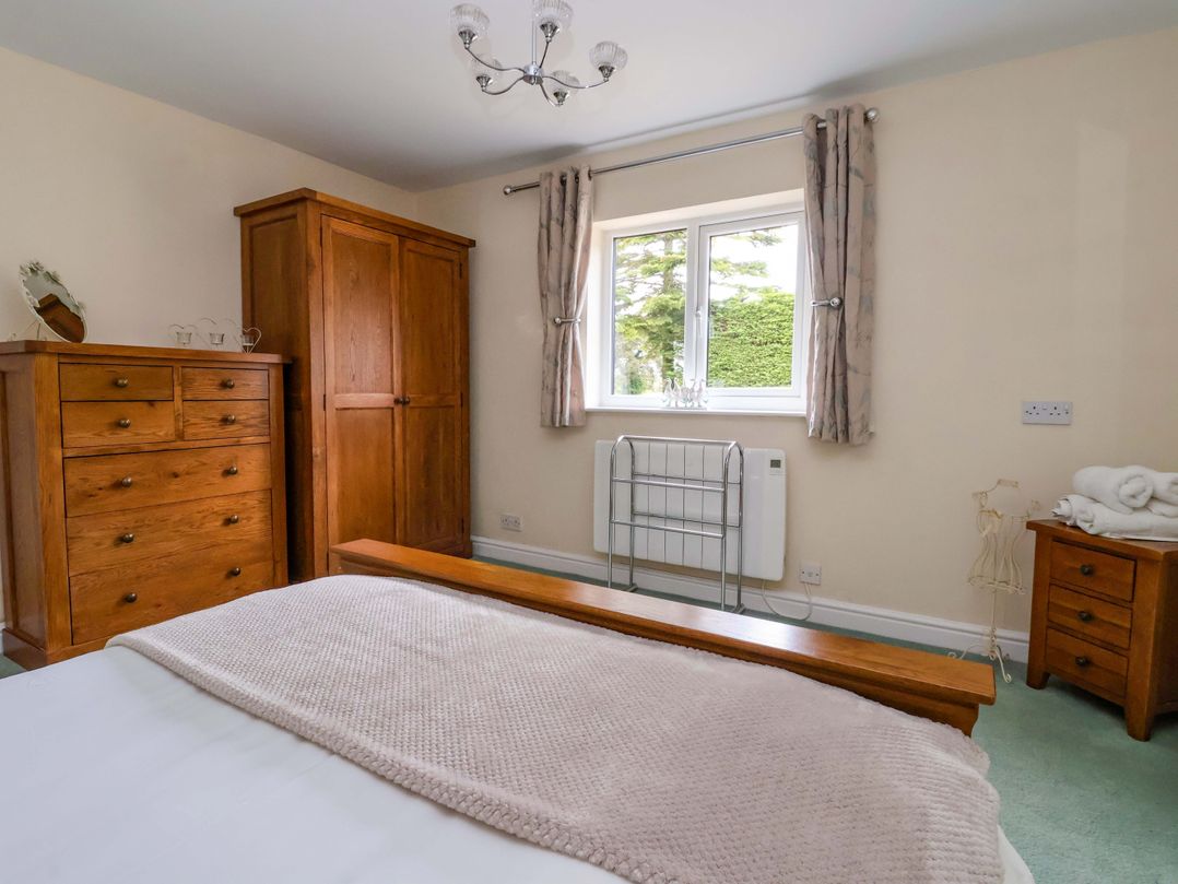 A bedroom with a bed and wardrobe at The Granary in York