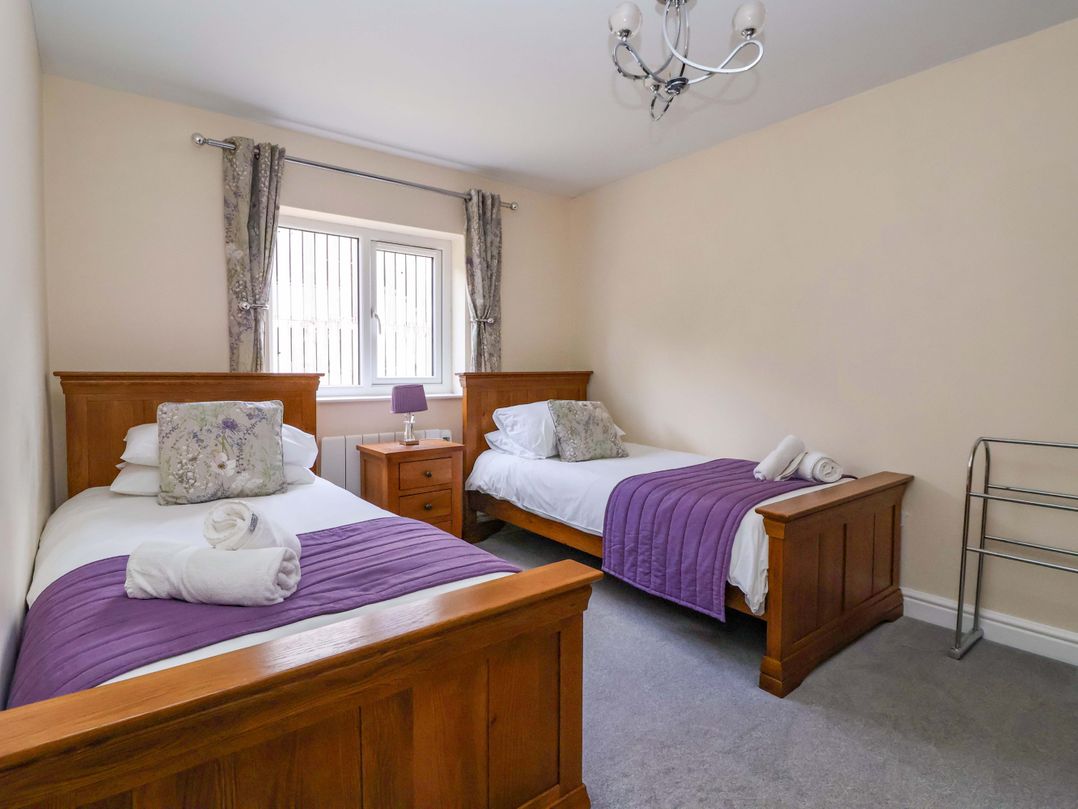 A bedroom with two beds and a window at The Granary in York