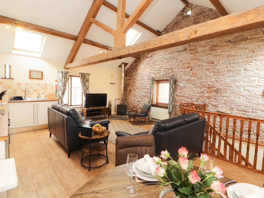 A living room with a couch and television at Stable Cottage in Bolton Low Houses