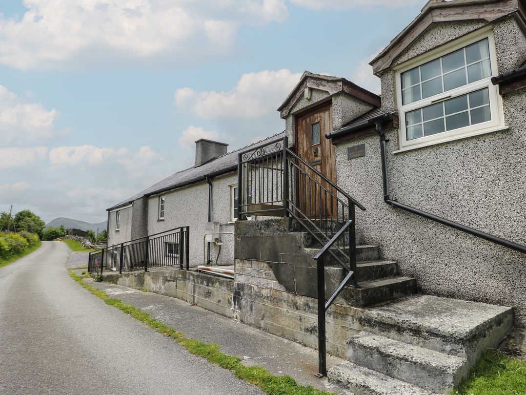 A house with a staircase and railing at Glan y Gors in Dinorwic near Llanberis