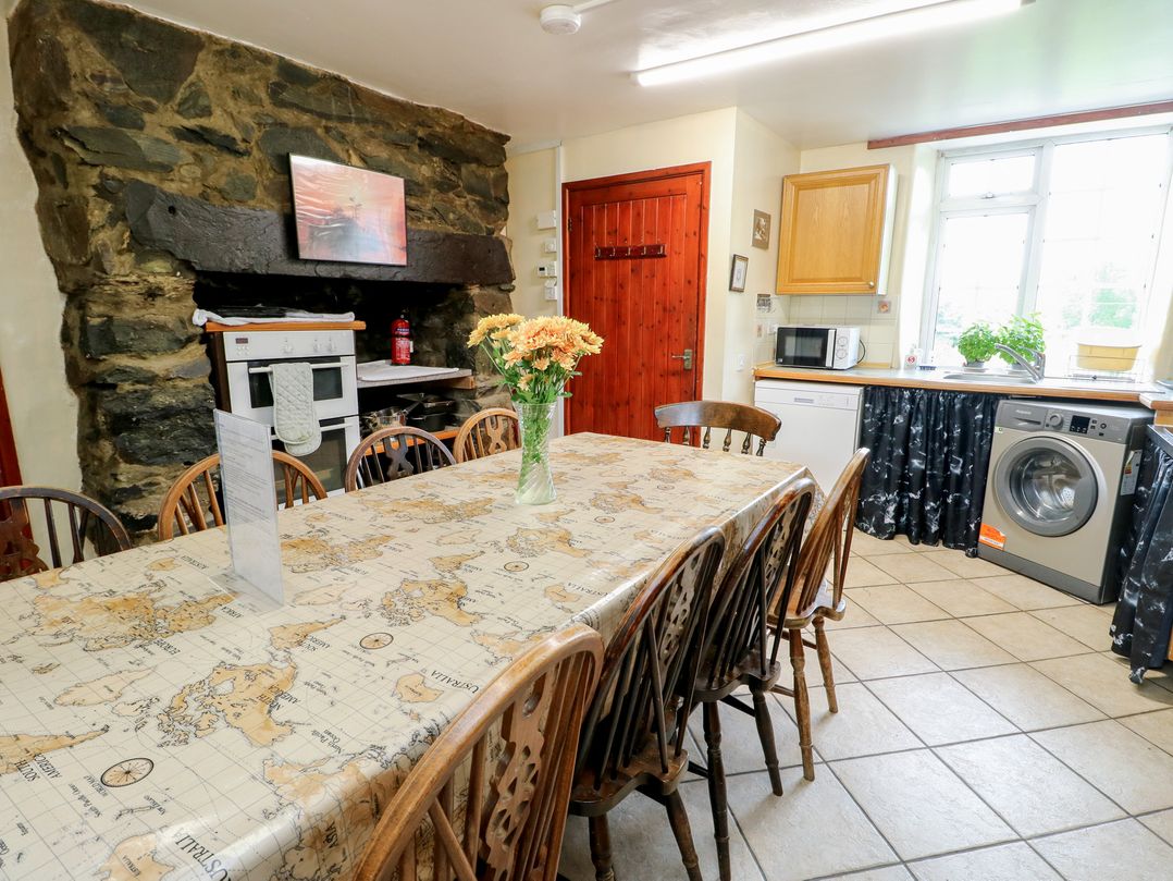 A kitchen with a large table and chairs at Glan y Gors in Dinorwic near Llanberis