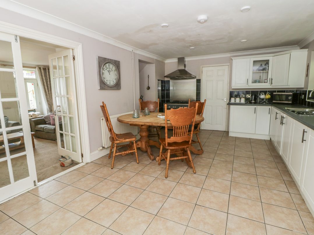 A kitchen with a round table and chairs at Teifi House in Cilgerran near Cardigan