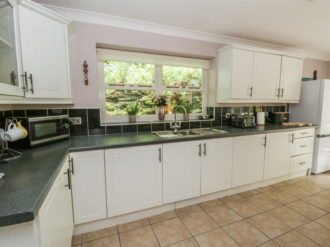 A kitchen with cabinets and countertop at Teifi House in Cilgerran near Cardigan