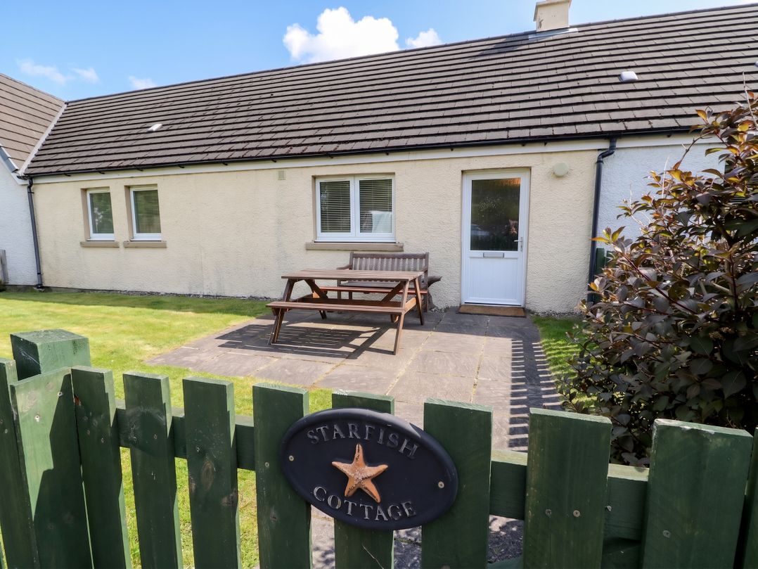 An outdoor area with a bench and pathway at Starfish Cottage, Craignure, Isle Of Mull