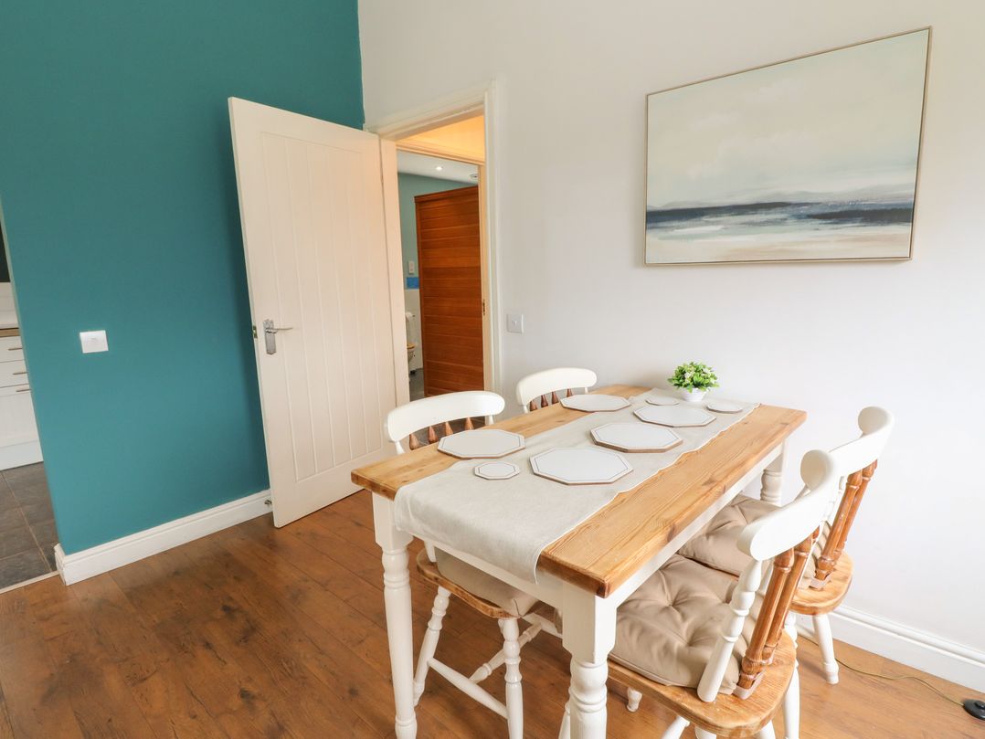 A dining room with a table and chairs at Starfish Cottage, Craignure, Isle Of Mull