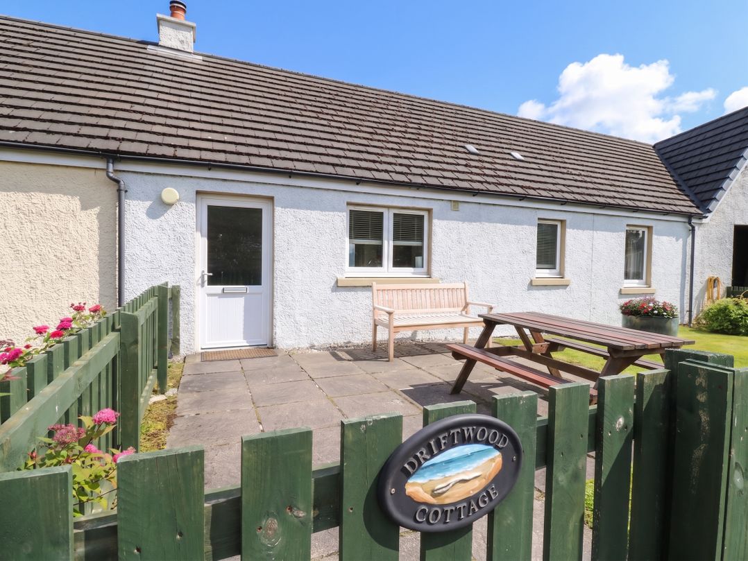 A house exterior with a bench and table at Driftwood Cottage, Craignure, Isle Of Mull