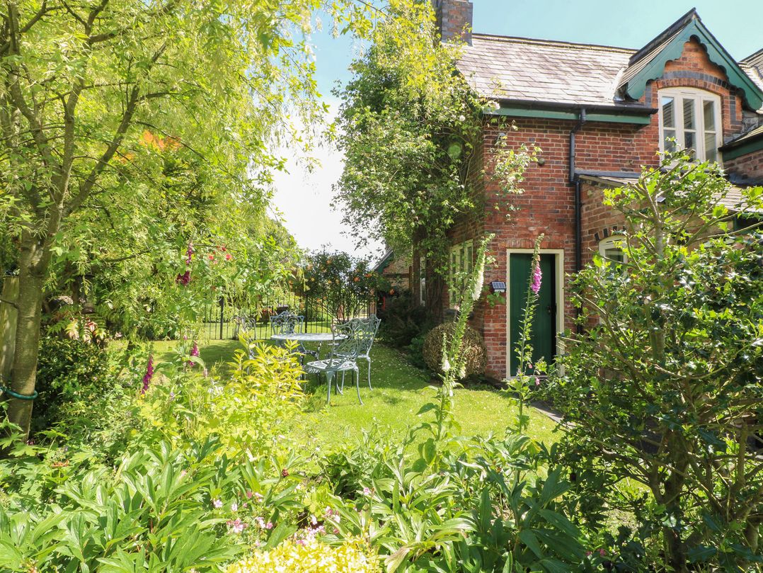 A garden with seating and greenery at Just A Cottage, Newlands Farm in Golden Valley near Riddings and Alfreton