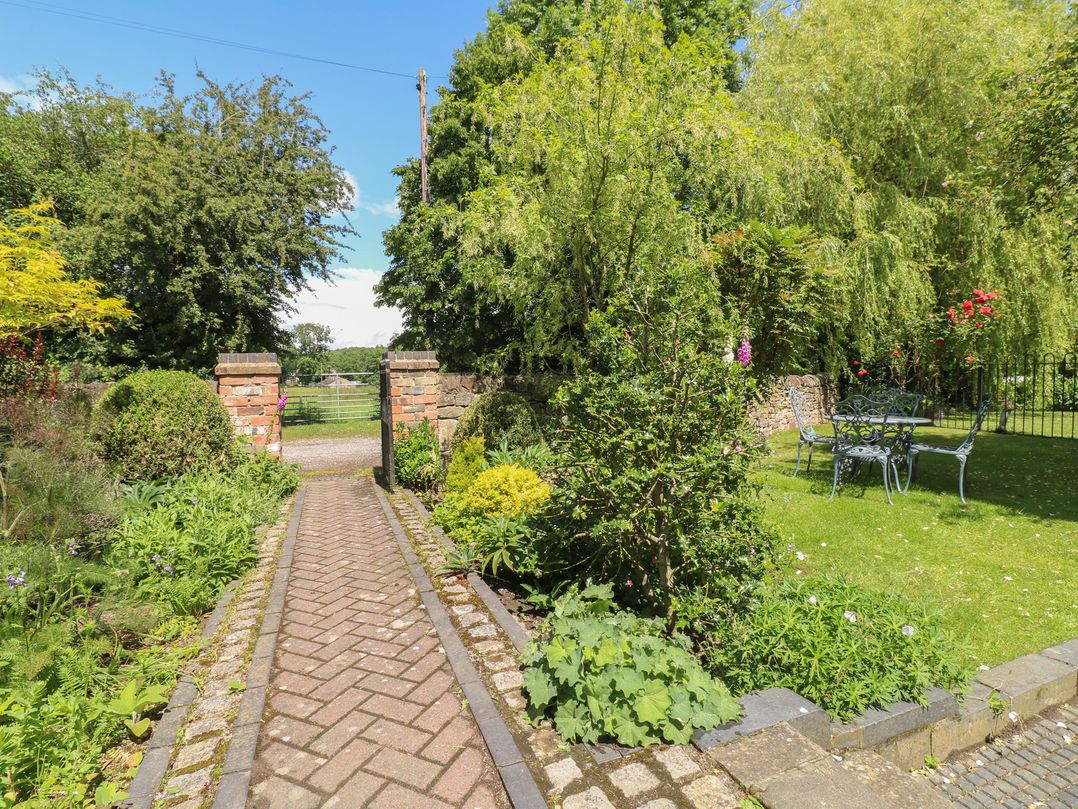 A garden pathway leading to a gate at Just A Cottage, Newlands Farm Golden Valley near Riddings and Alfreton