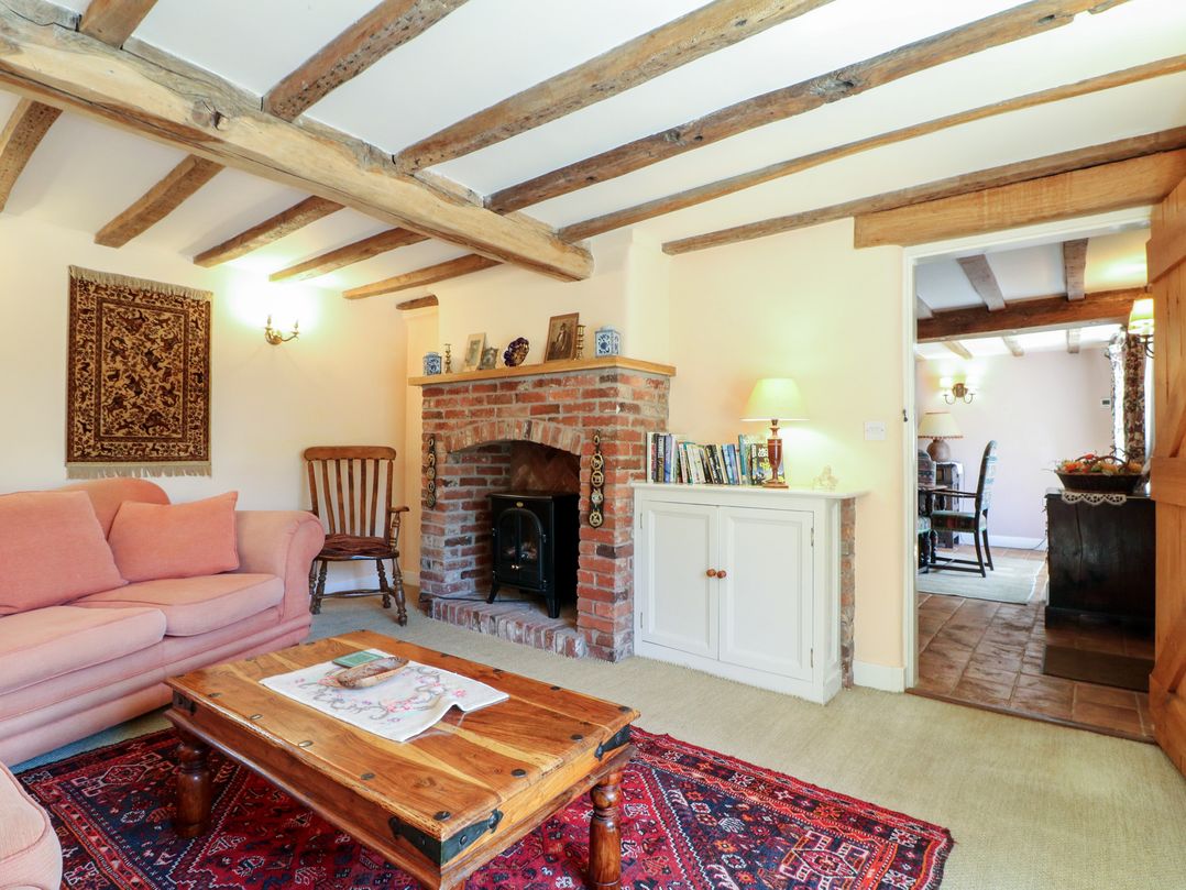 A living room with a sofa and coffee table at Just A Cottage, Newlands Farm in Golden Valley near Riddings and Alfreton