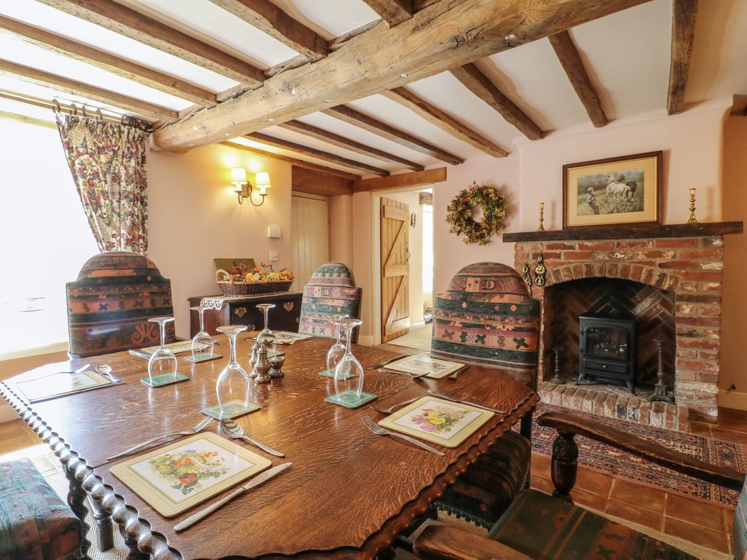 A dining room with a large table and chairs at Just A Cottage, Newlands Farm, Golden Valley near Riddings and Alfreton