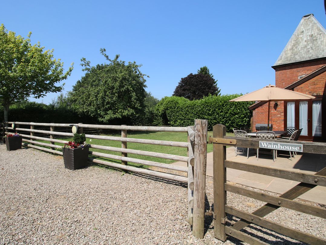 An outdoor area with a table and chairs under an umbrella at The Wainhouse in Bockleton near Tenbury Wells