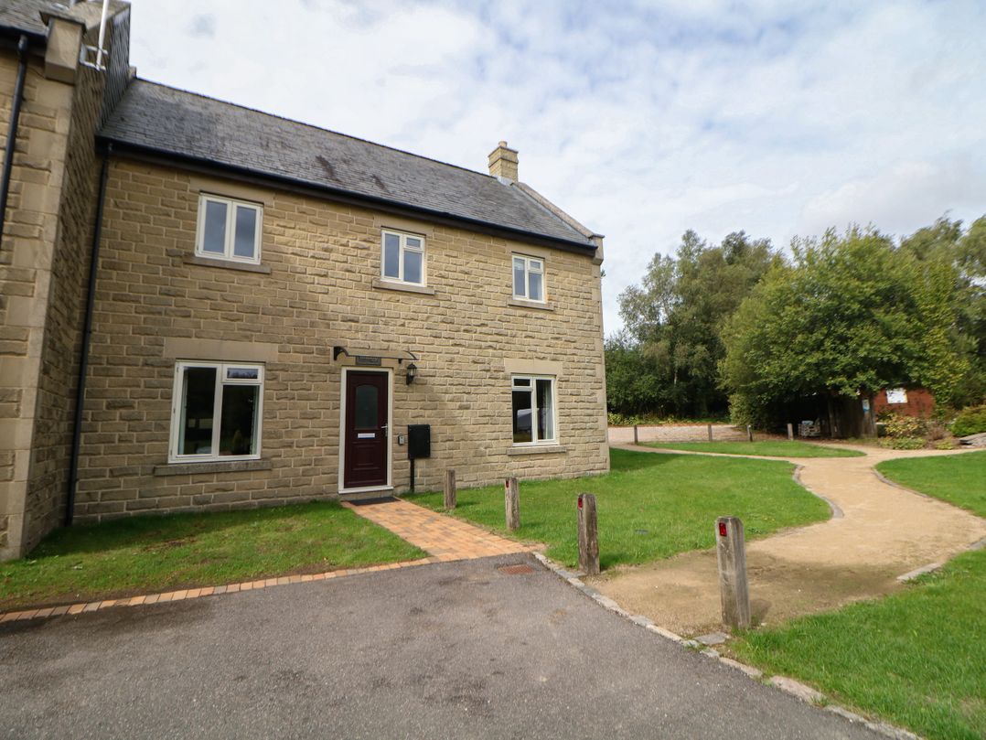 A house with a door and windows beside a path at Wensley in Matlock