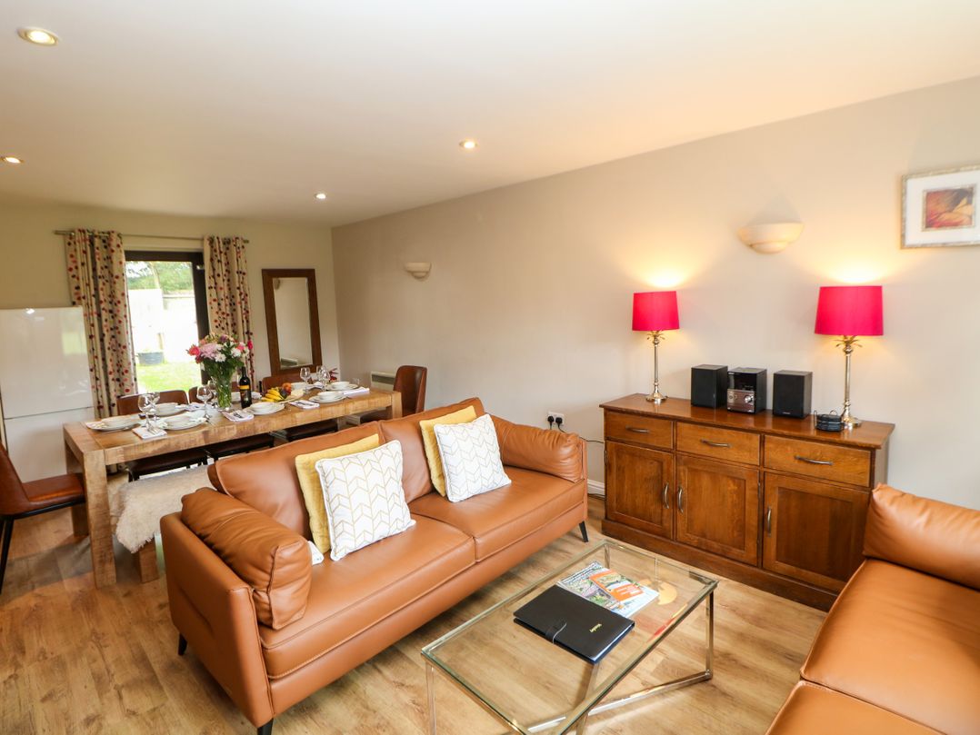 A living room with sofa and dining area at Wensley in Matlock