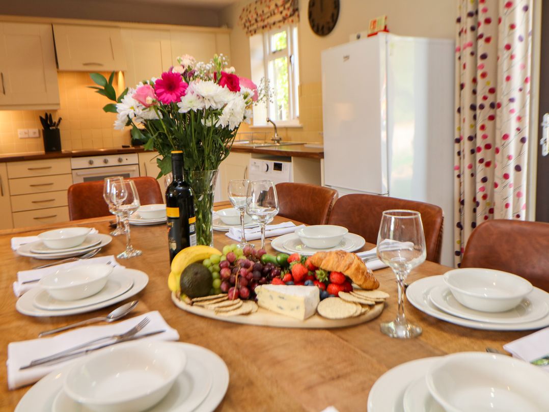 A kitchen with a dining table set for a meal at Wensley in Matlock