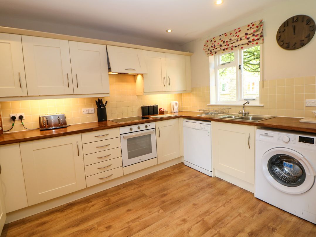 A kitchen with appliances and cabinets at Wensley in Matlock