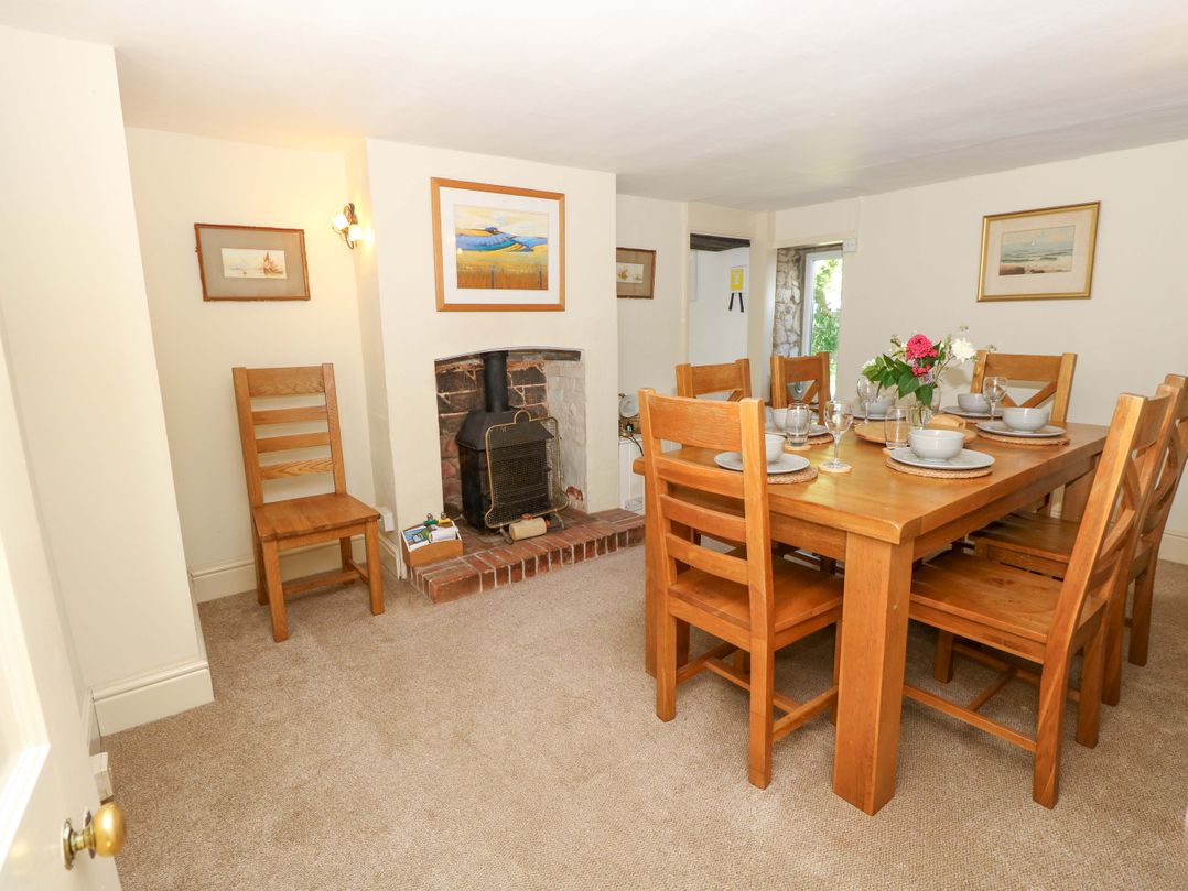 A dining room with a table and chairs at Sweet Briars in Chale
