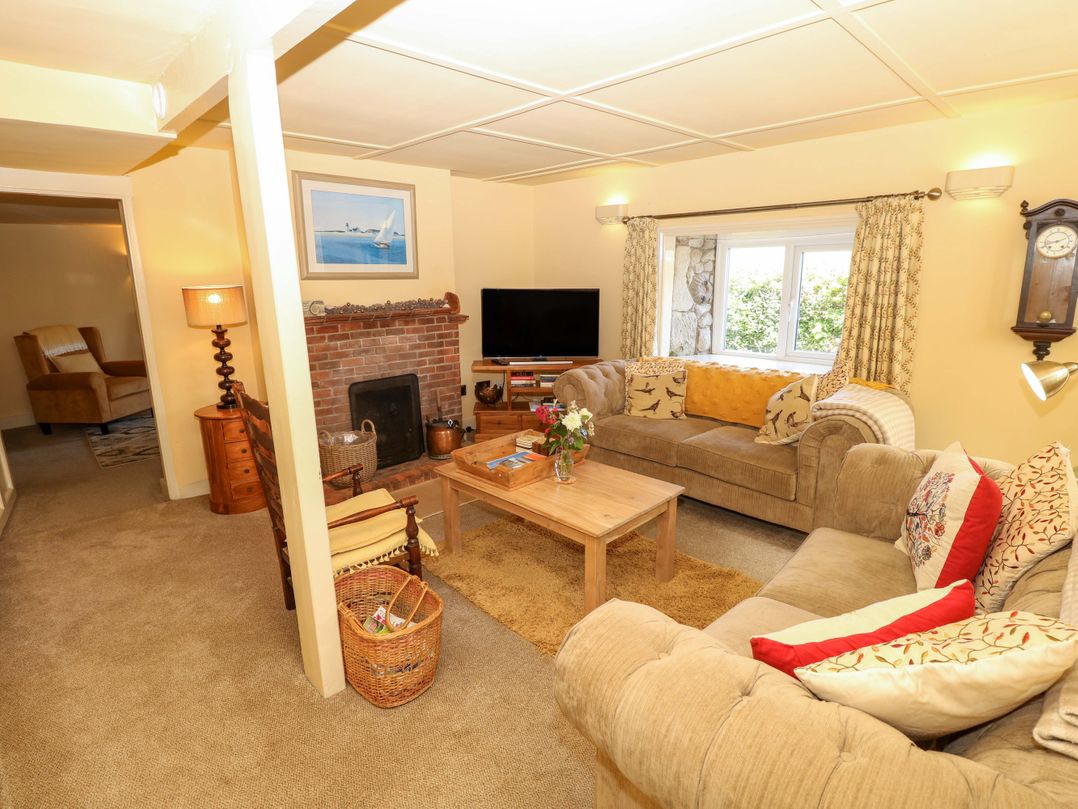 A living room with a sofa and armchair at Sweet Briars in Chale