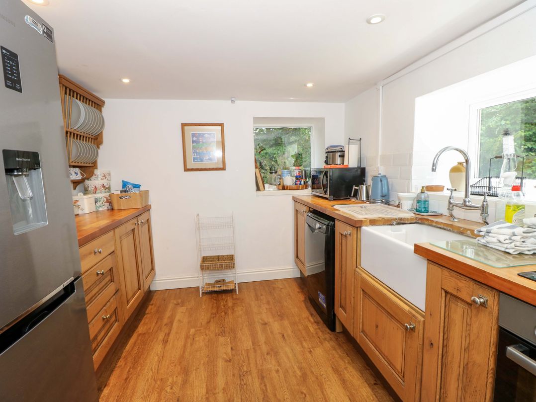 A kitchen with a sink and refrigerator at Sweet Briars Chale
