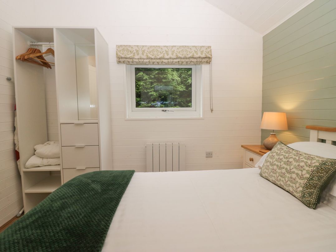 A bedroom with a bed and wardrobe at Ash Lodge Pennington near Ulverston