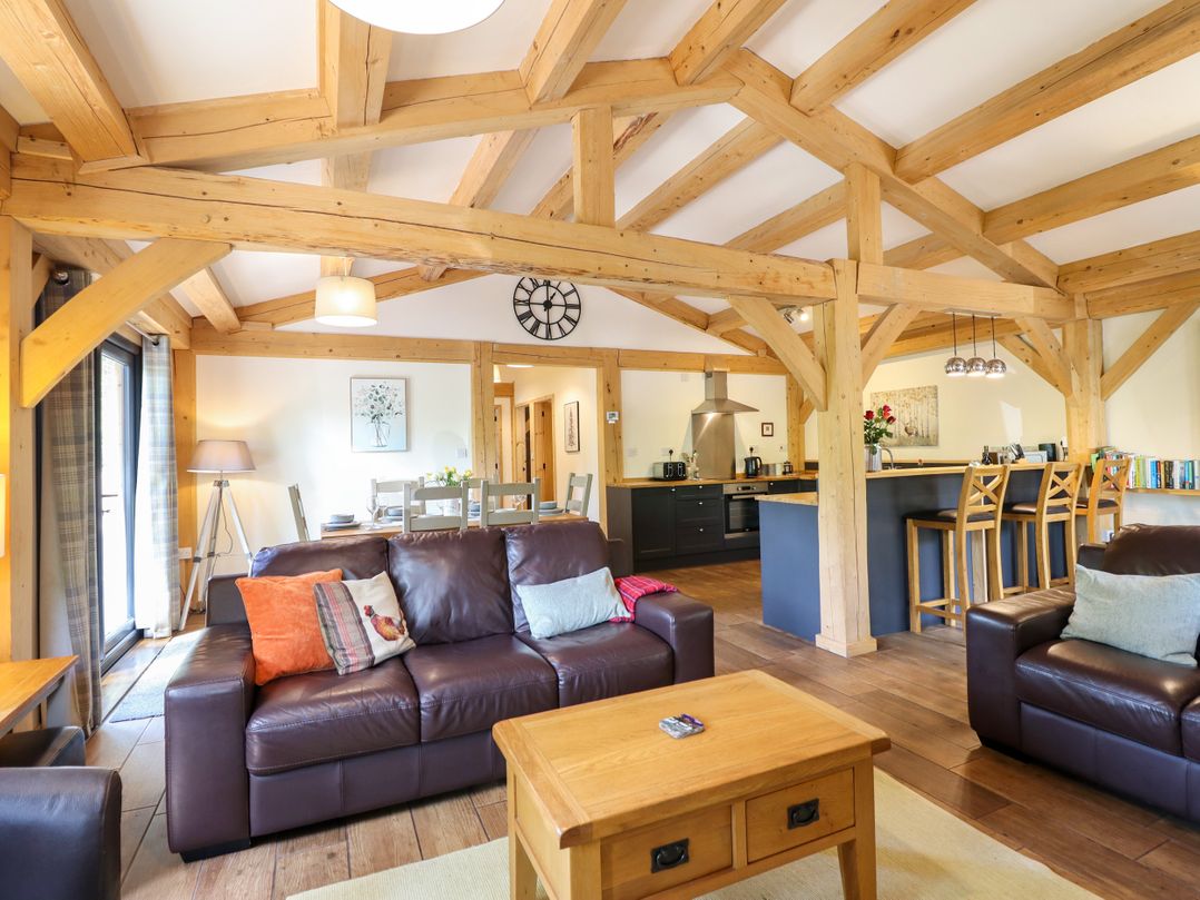 A living room with a sofa and coffee table at Lady Bagots Cabin Ruthin