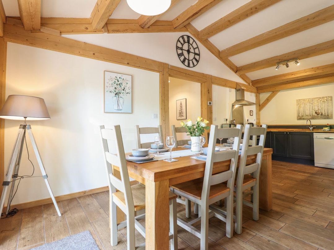 A dining room with a table and chairs at Lady Bagots Cabin in Ruthin