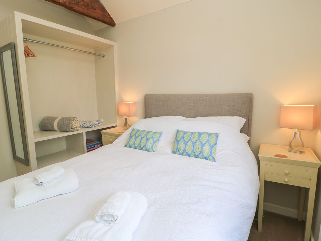 A bedroom with a double bed and bedside table at The Cider Press, Motcombe