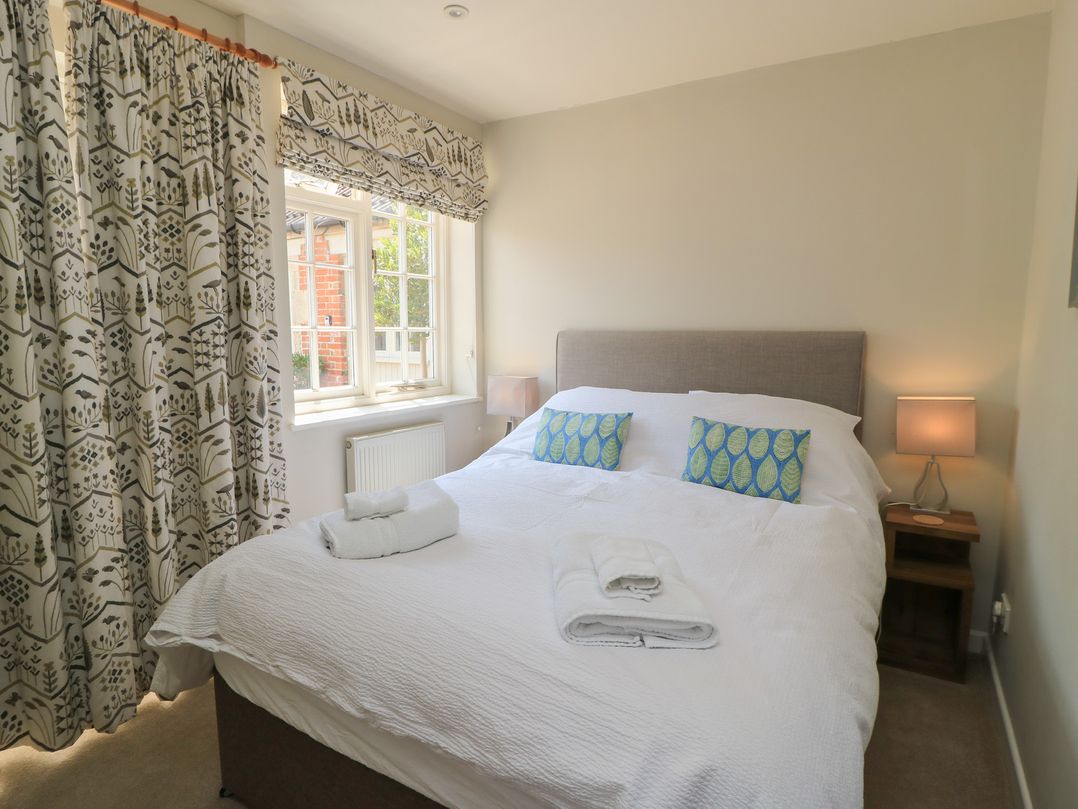 A bedroom with a bed and window at The Apple Shed, Motcombe