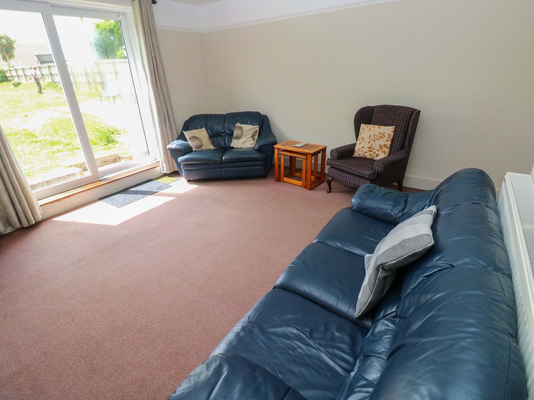 A living room with a sofa and coffee table at White Thorns in Haverfordwest