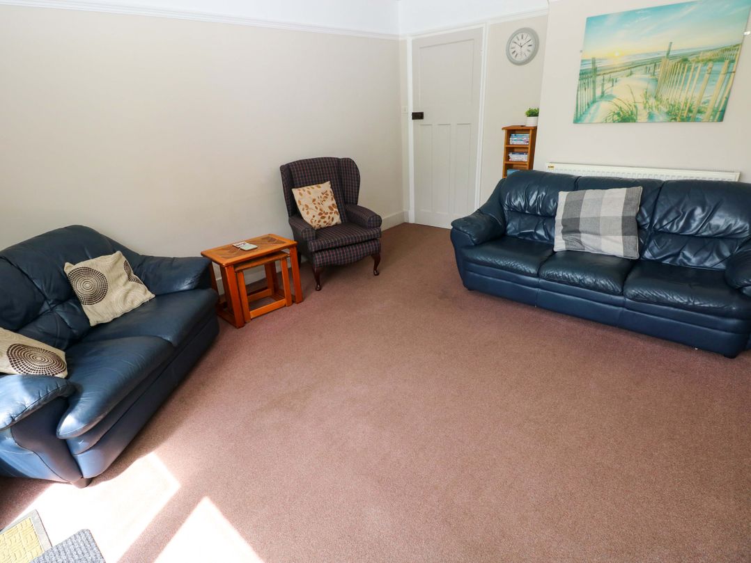 A living room with two sofas and an armchair at White Thorns in Haverfordwest