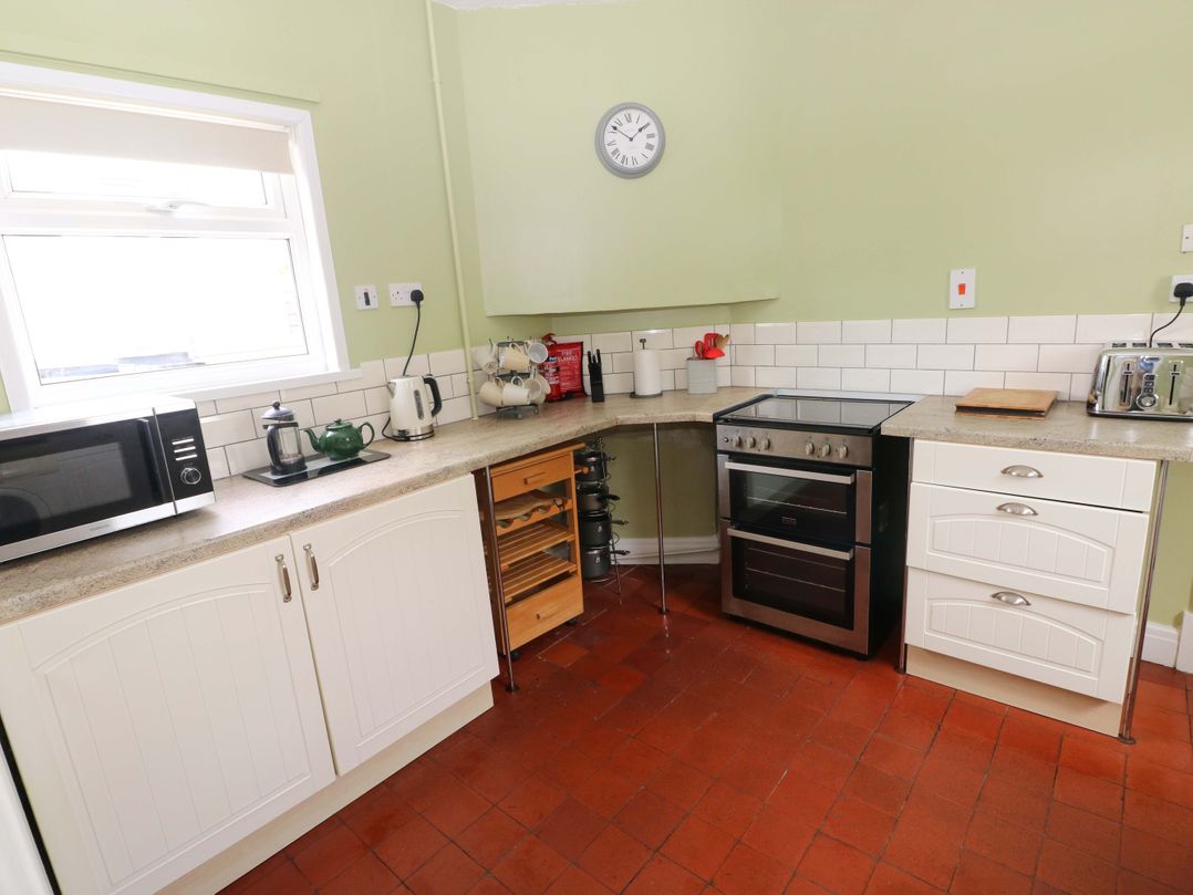 A kitchen with microwave, oven and kettle at White Thorns in Haverfordwest