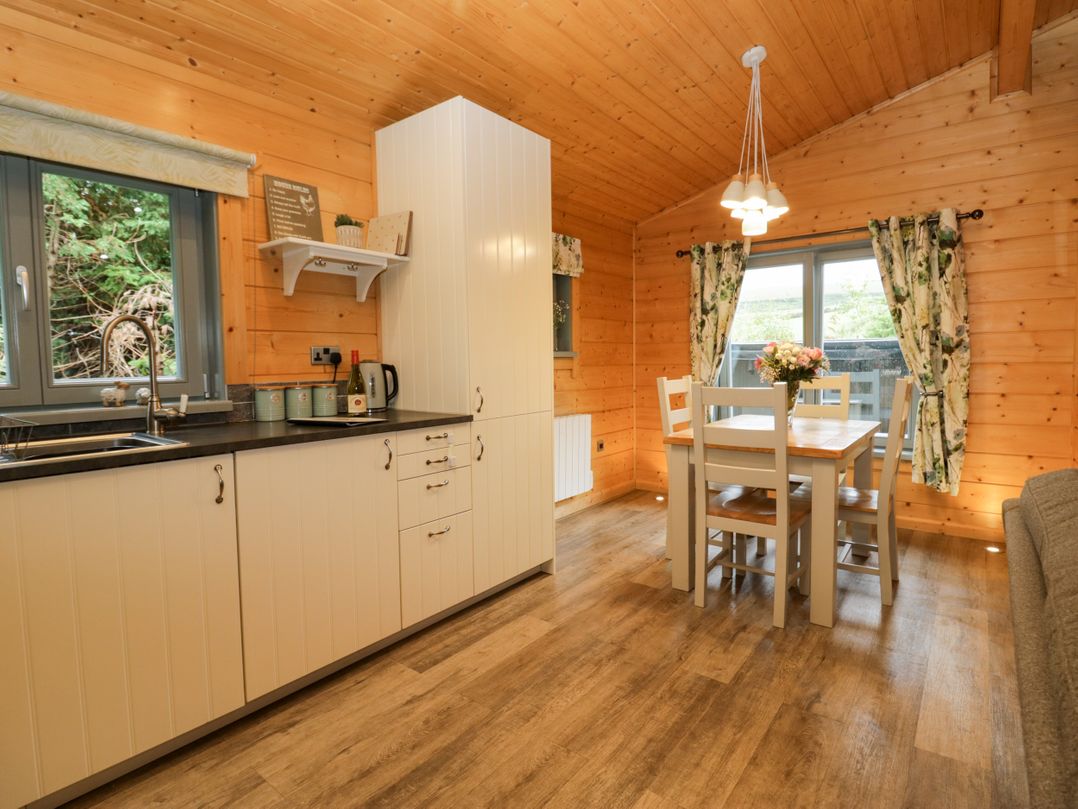 A kitchen with a dining table and chairs at Elm Lodge in Ulverston