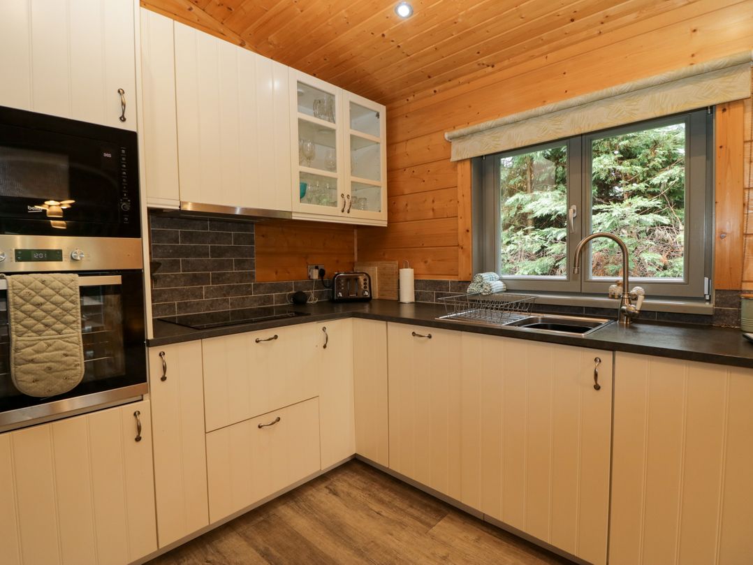 A kitchen with a sink and oven at Elm Lodge in Ulverston