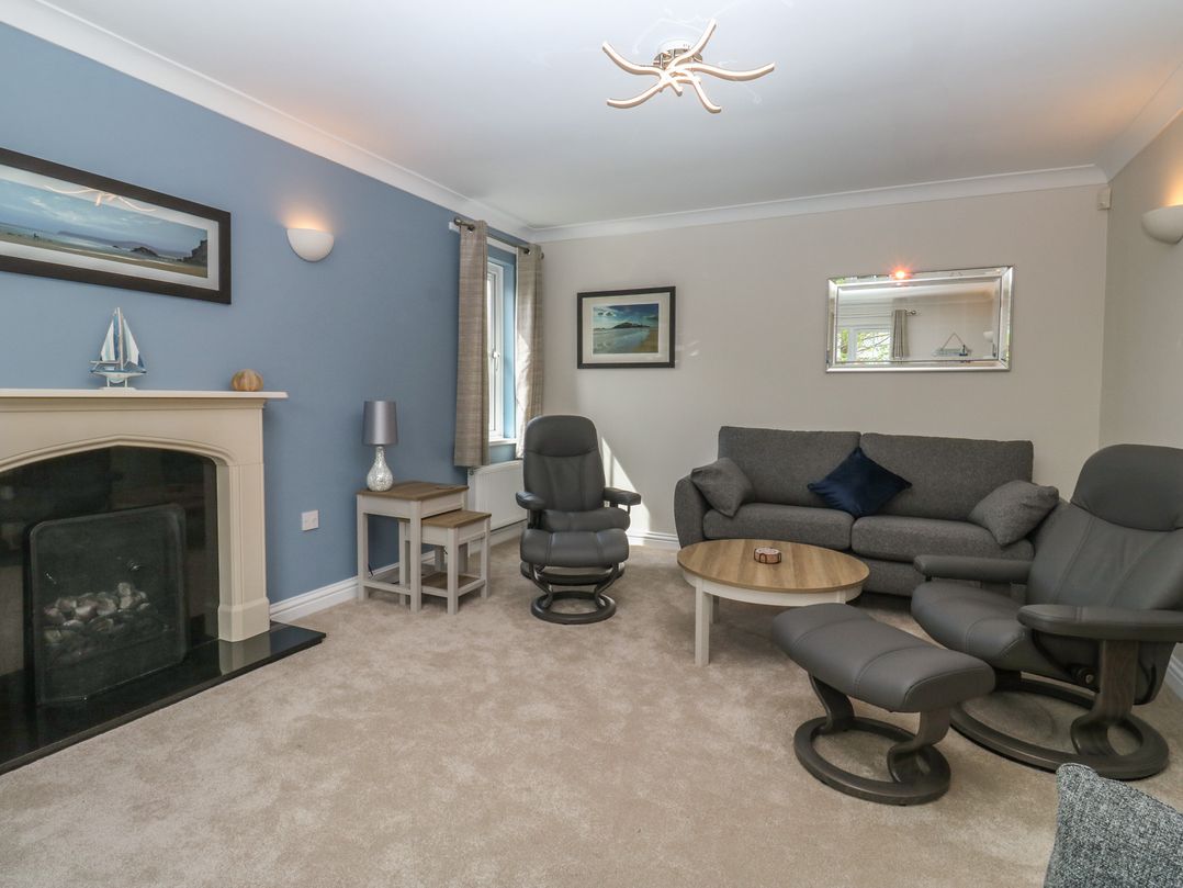 A living room with sofa and armchairs at Glebe House in Bigbury