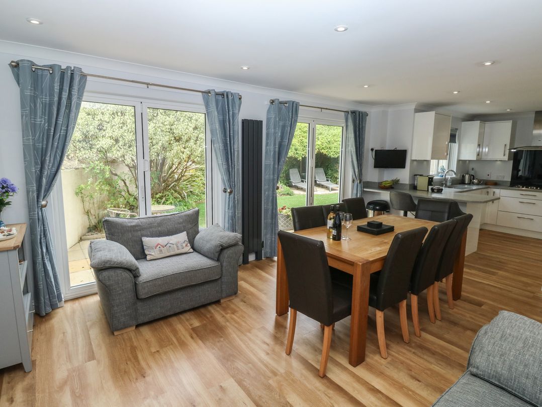 A dining room with a table and chairs at Glebe House in Bigbury