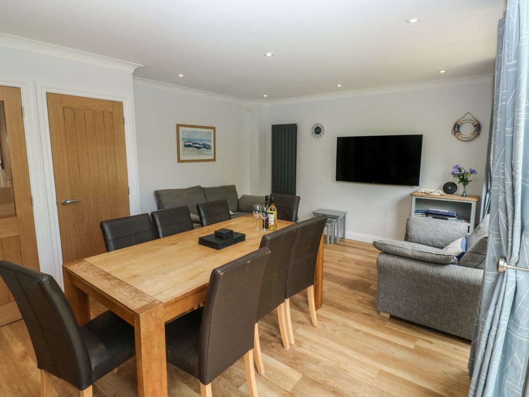 A dining room with a table and chairs at Glebe House Bigbury