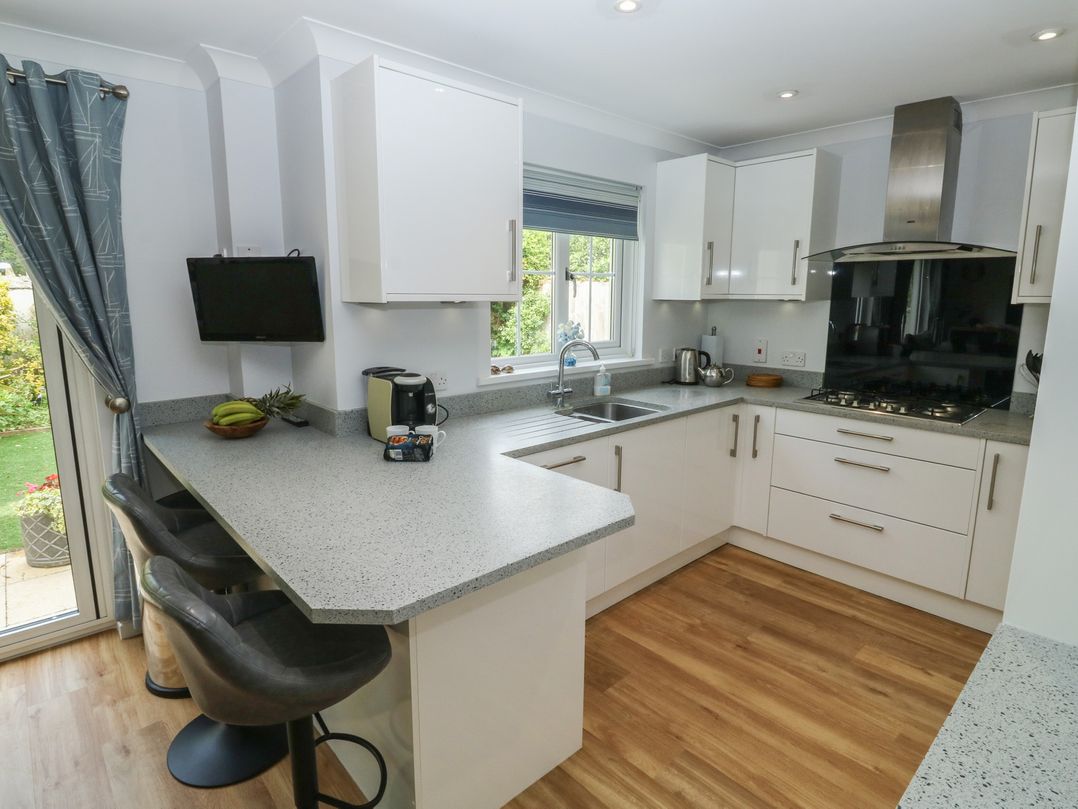 A kitchen with a sink and stove at Glebe House in Bigbury
