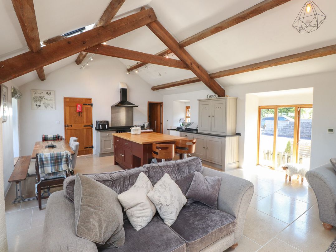 A kitchen with a dining area and seating at Wern Olau Cottage Groeslon near Caernarfon