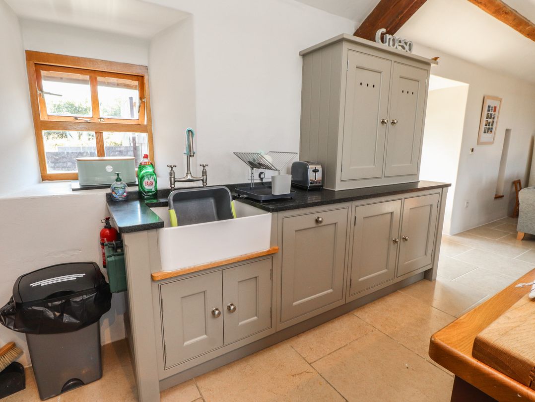 A kitchen with a sink and cupboards at Wern Olau Cottage Groeslon near Caernarfon