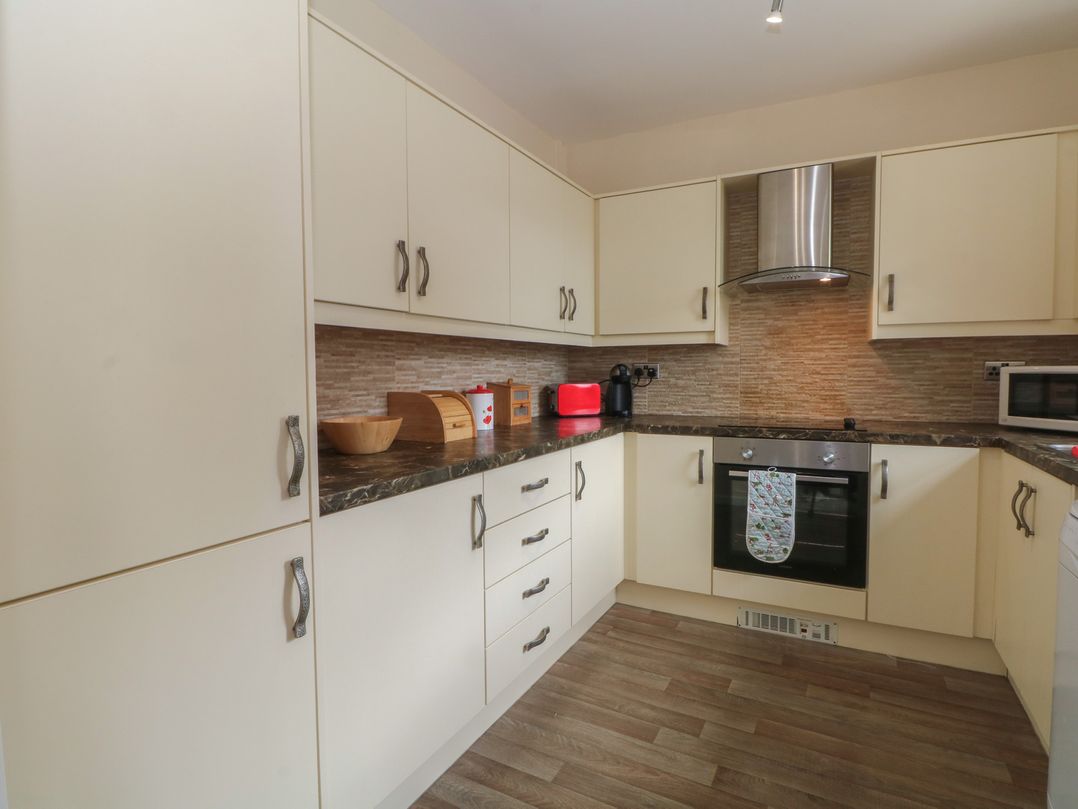 A kitchen with cabinets, oven, and countertop at West End House in Thornton, West Yorkshire
