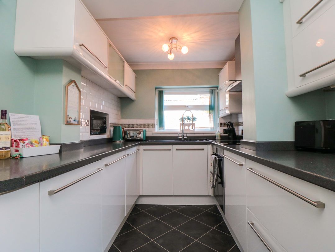 A kitchen with sink and window at Sands End Cottage, Marske-by-the-Sea