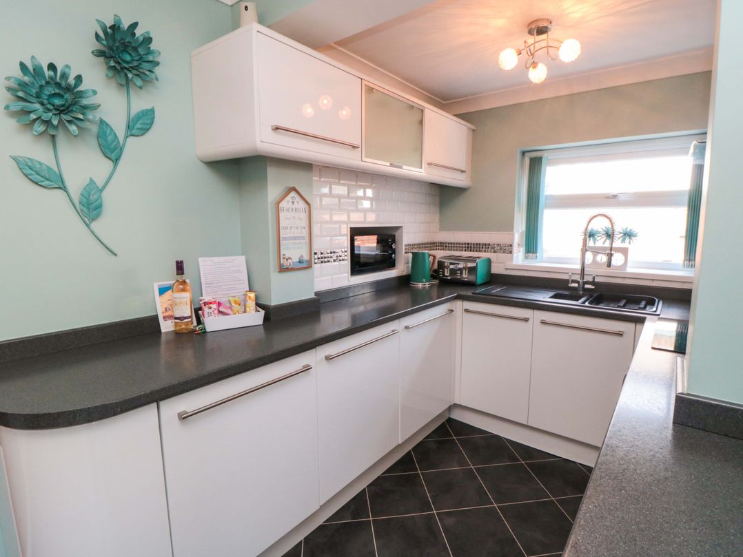 A kitchen with modern fixtures and decor at Sands End Cottage in Marske-by-the-Sea