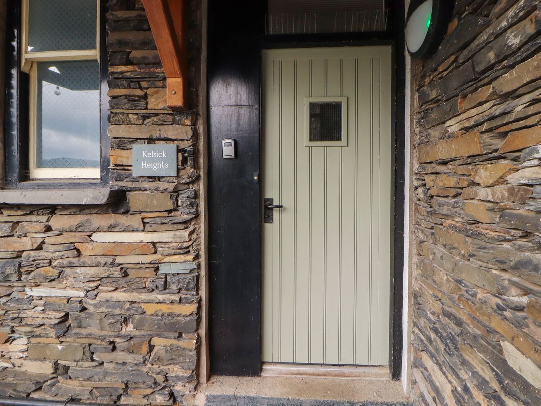 An entrance with a door and sign at Kelsick Heights Ambleside