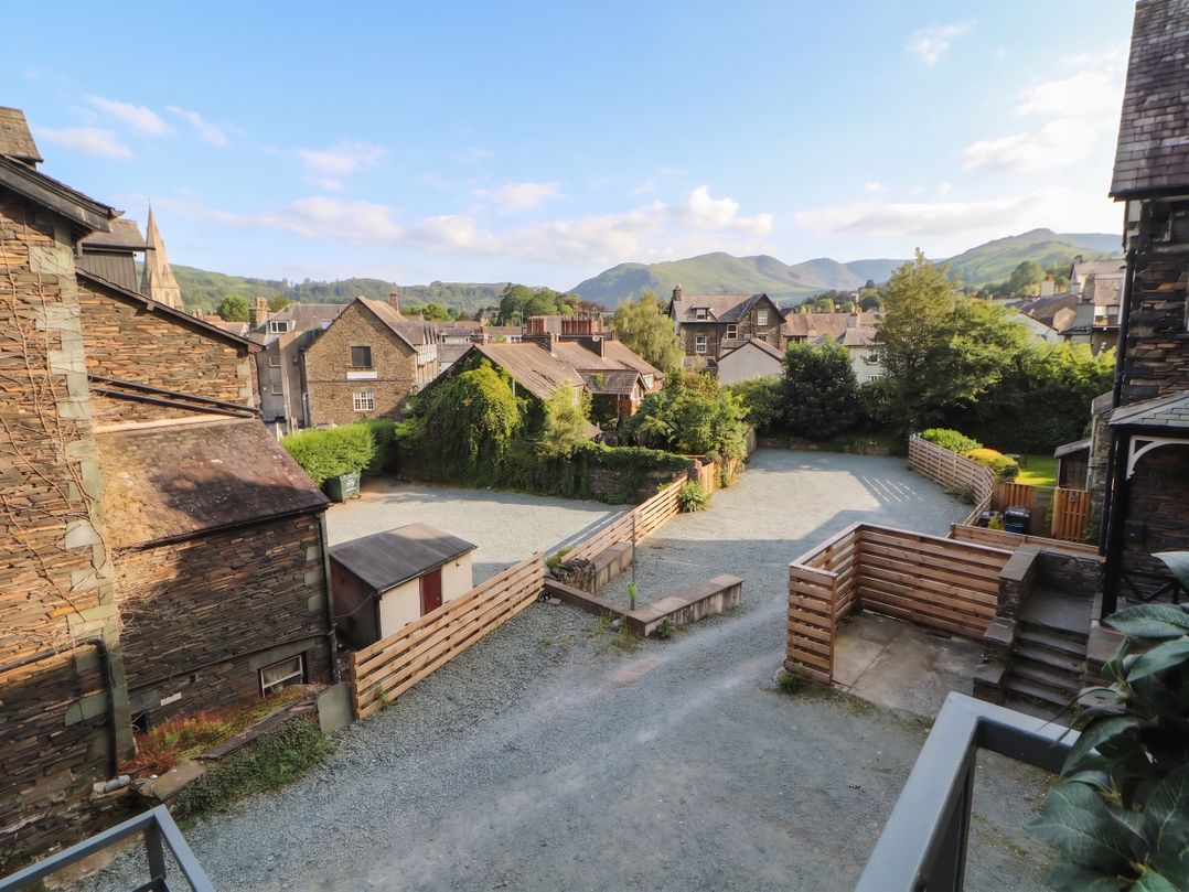 An outdoor area with buildings and mountains at Kelsick Heights in Ambleside