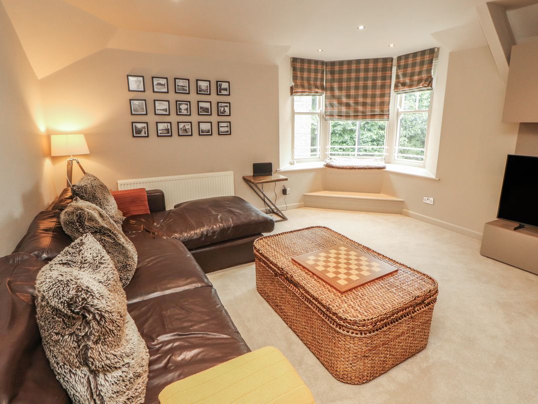 A living room with a sofa and checkers board at Kelsick Heights in Ambleside