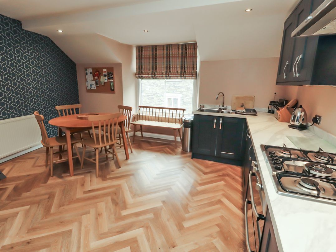 A kitchen with a table and chairs at Kelsick Heights in Ambleside