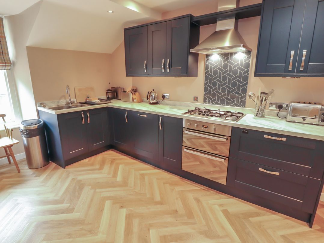 A kitchen with cabinets and appliances at Kelsick Heights Ambleside