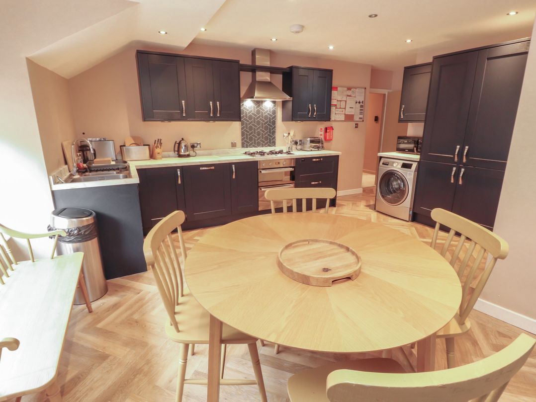 A kitchen with a dining table and chairs at Kelsick Heights in Ambleside