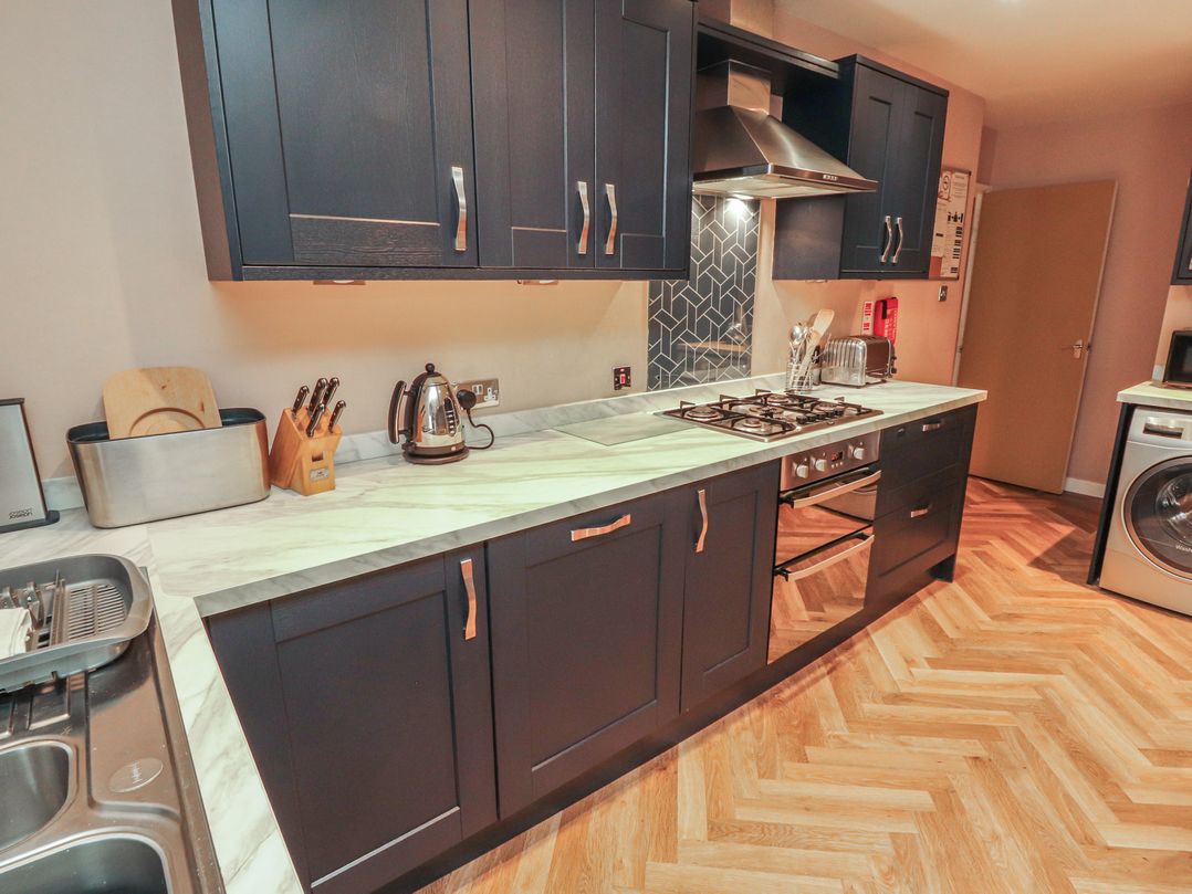 A kitchen with cabinets and countertop at Kelsick Heights in Ambleside