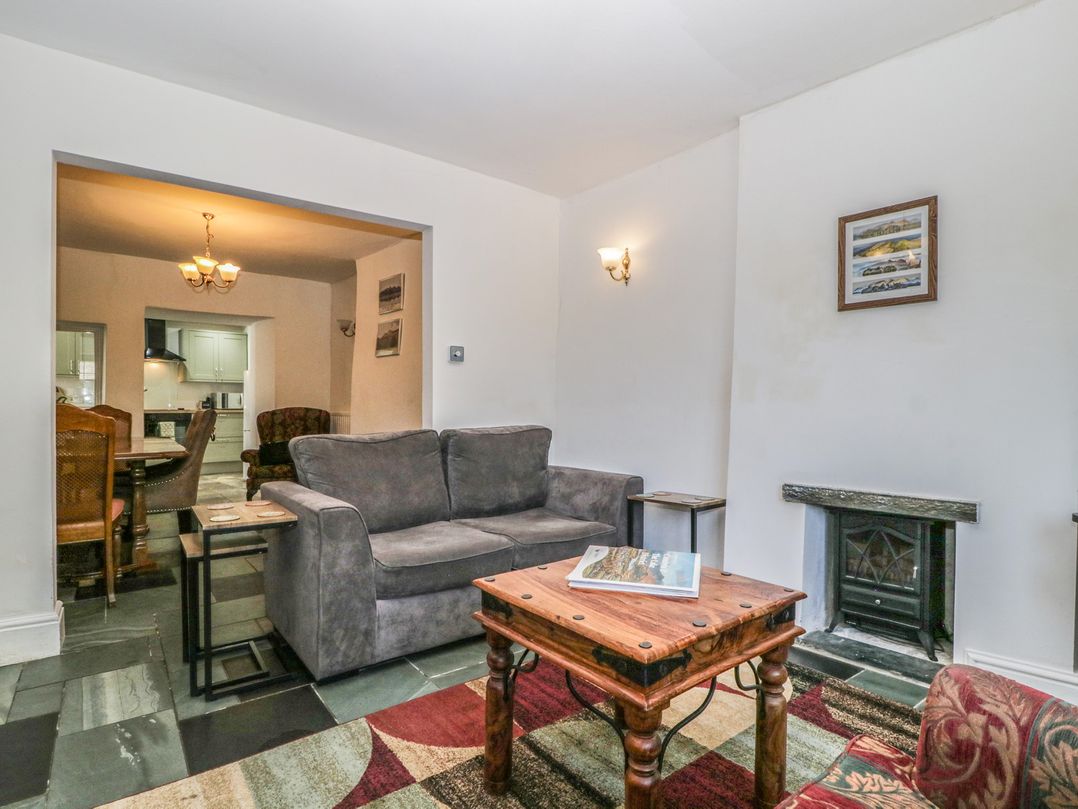 A living room with a sofa and coffee table at Fountain Cottage in Keswick